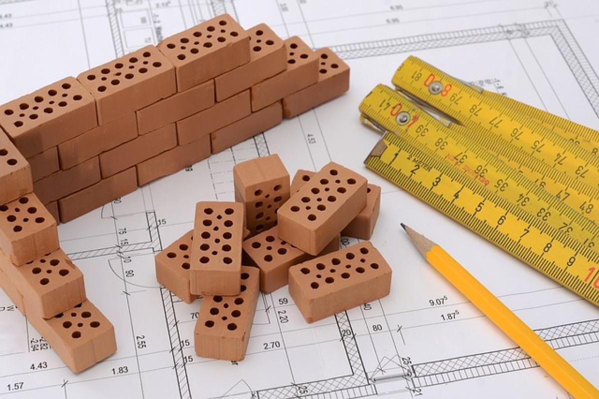 Mini bricks, yellow ruler, pencil on architectural plans.